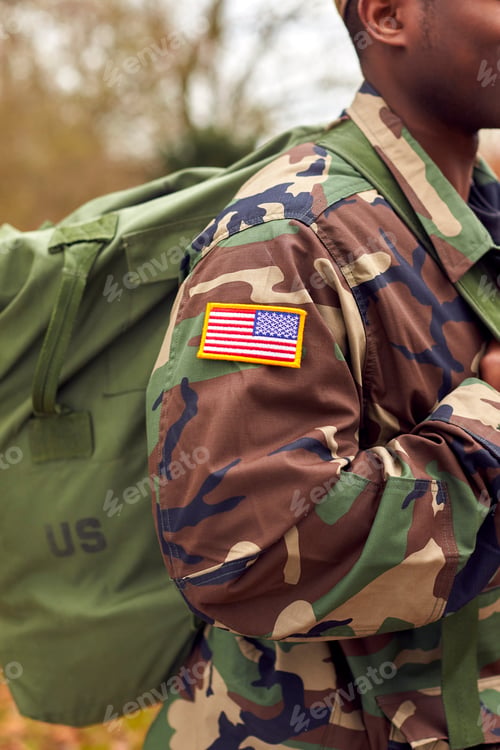 Preview: Close Up Of American Flag On Uniform Of Soldier Carrying Kitbag Returning Home On Leave