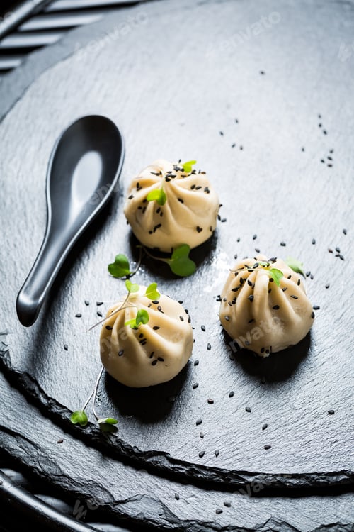 Preview: Boiled and hot manti dumplings on black rock