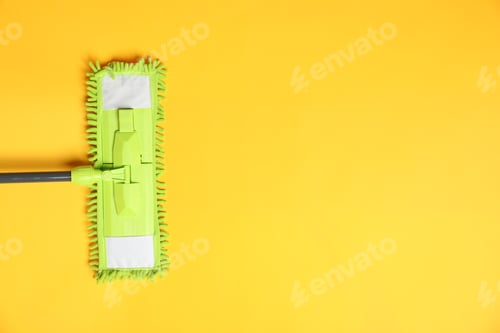 Preview: Microfiber mop on yellow background, top view. Space for text