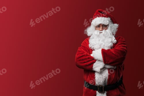 Preview: Confident Santa Claus with a stern look stands with arms folded