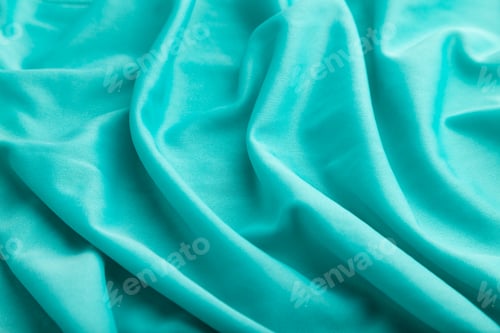 Preview: Fragment of silk blue tissue. Side view, natural textile background.