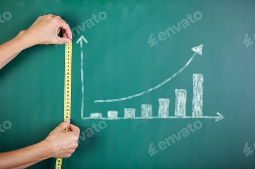 Preview: Closeup Of Woman'S Hands Measuring Bar Graph With Tape On Blackboard