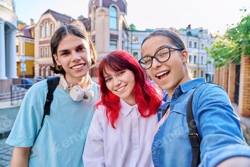 Preview: Having fun happy teenagers looking at camera, taking selfie