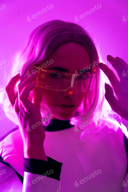 Preview: A woman in a suit and futuristic glasses with pink lights, virtual or metaverse concept, looking