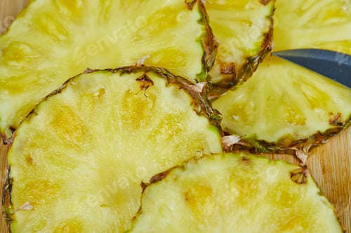 Preview: Slices of pineapple on wooden board, close up