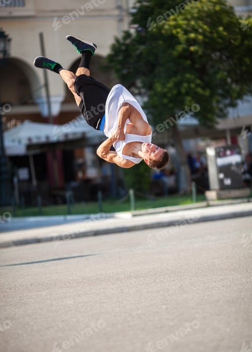 Preview: Man doing acrobatic tricks in city street