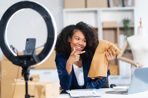 Preview: A young African American woman with afro brown hair works in modern office, management clothing