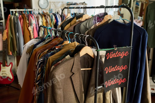 Preview: Clothing Rack Displaying Vintage Jackets and Shirts in Thrift Shop Setting