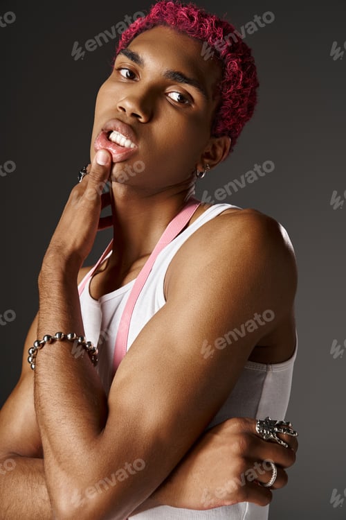 Preview: portrait of good looking man posing with fingers on lips and looking at camera, fashion concept