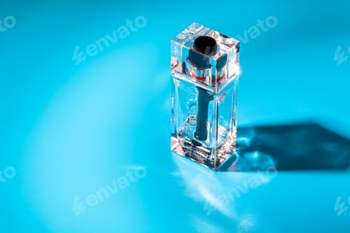 Preview: perfume glass bottle on light blue background. Eau de toilette