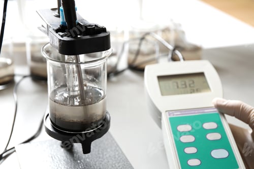 Preview: Scientist measuring acidity and pH of soil at table, closeup. Laboratory analysis