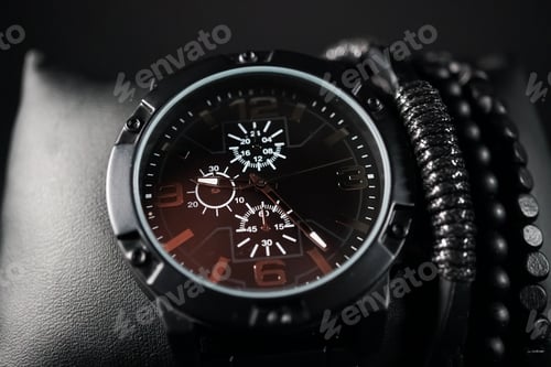 Preview: Closeup shot of a men's elegant wristwatch and bracelets