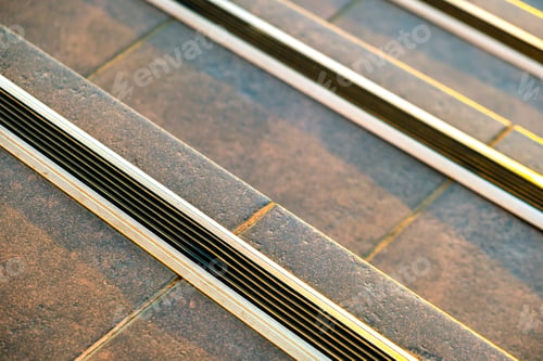 Preview: Closeup of ceramic tiles covering porch stairs with rubber anti slippery stripes on it