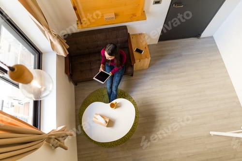 Preview: Top view of woman use of the tablet pc