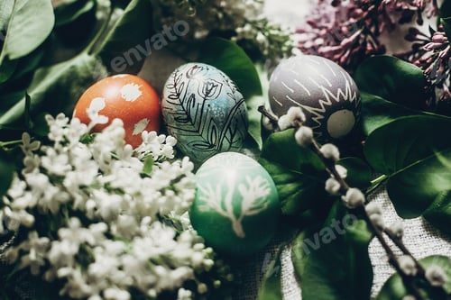 Preview: easter eggs with lilac flowers on rustic background