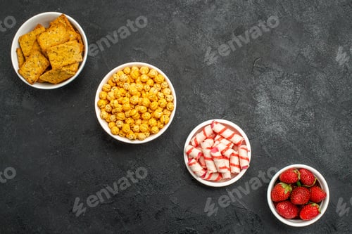 Preview: top view different eatings crisps fruits and candies on dark background tea sweet photo crisp