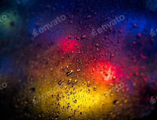 Preview: Abstract view of raindrops on window with blurred colors in background