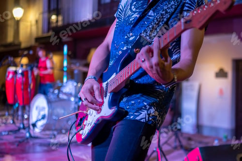 Preview: Rock and roll group performing live at night