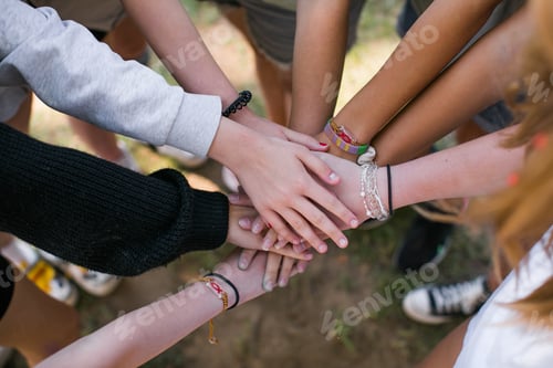 Preview: Team of children put hands together.Peaceful Protest kids group and protester unity