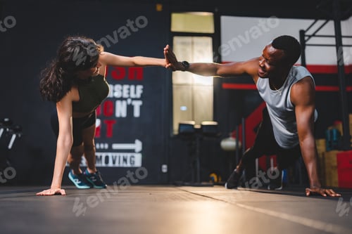 Preview: Young fit and health conscious girlfriend and boyfriend clapping hands while practicing single hand