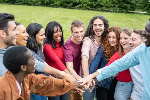 Preview: Multiracial people joining hands together, happy friends, peace and love concept