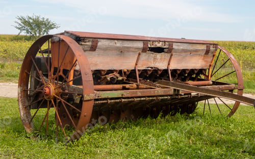 Preview: an old grain cart in the middle of the field next to a field