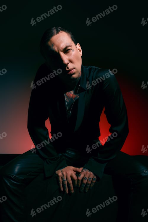 Preview: Striking pose of a handsome stylish man in a dramatic light display showcasing modern fashion