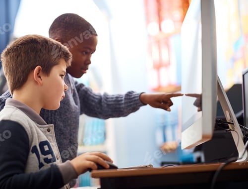 Preview: Shot of elementary school kids using a computer while working in class
