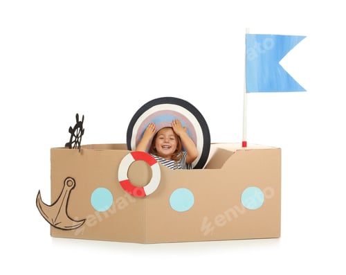 Preview: Cute little girl playing with cardboard ship on white background