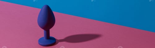 Preview: Blue buttplug sex toy on a colorful background. Photo of anal toy for adult with