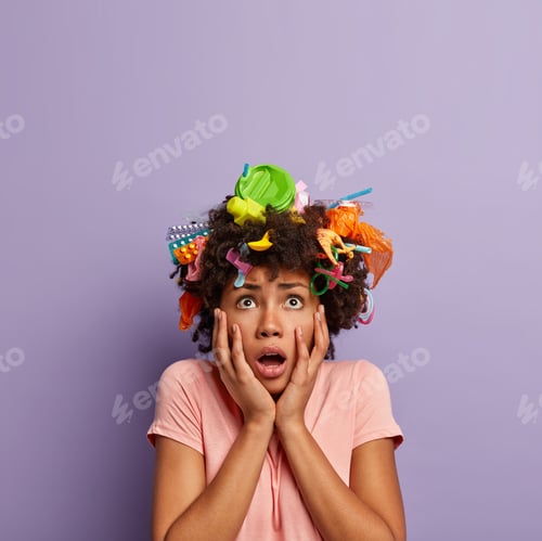Preview: Environment pollution problem. Horrified scared Afro woman focused above, has different plastic tras