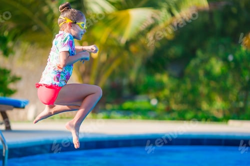 Preview: Little happy girl having fun in outdoor swimming pool