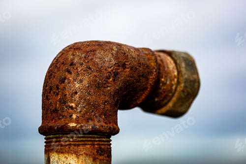 Preview: Detailed close-up photograph of an old, rusted metal pipe