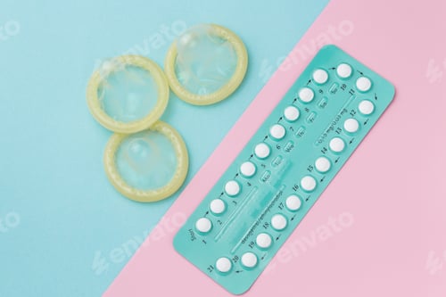Preview: Contraceptive pills and condoms on colored background. View from above. Concept of birth control