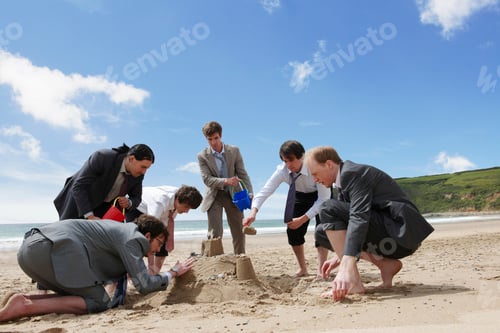 Preview: Businessmen building sand castle