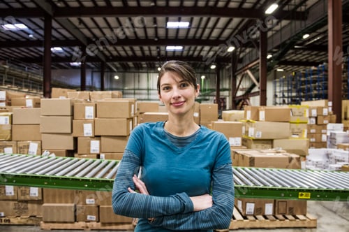 Preview: A caucasian female warehouse worker in a distribution warehouse.