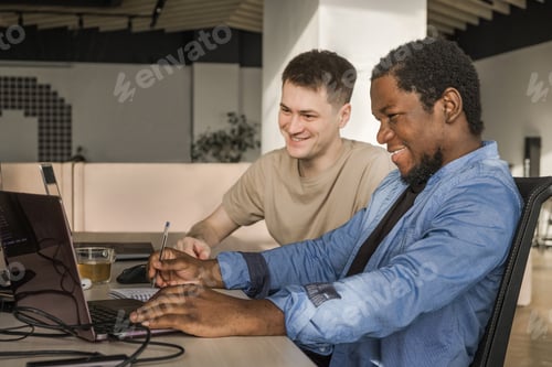 Preview: Two smiling positive programmers working in the office of a software development company. Coding