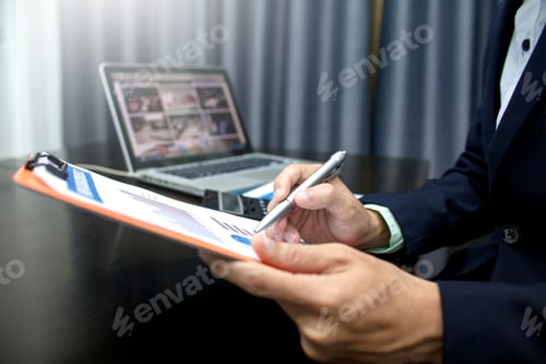 Preview: Businessman analyzing business information documents in the workplace.