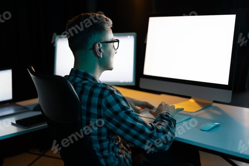 Preview: Man Working On Computer At Night In Office