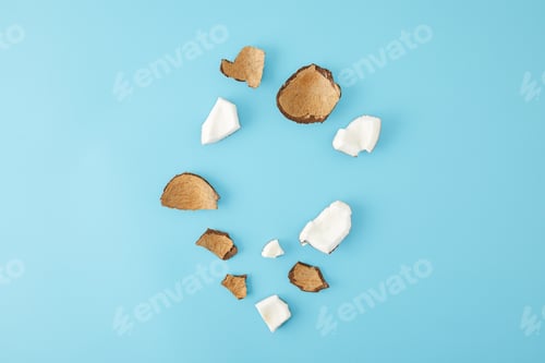 Preview: top view of arranged coconut pieces isolated on blue