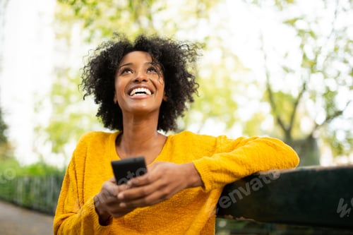 Preview: Attractive young woman with phone outside in the city