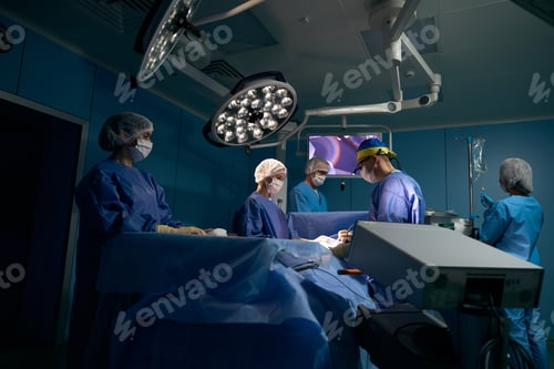 Preview: Teamwork of a surgeon, anesthetist and assistants in operating room