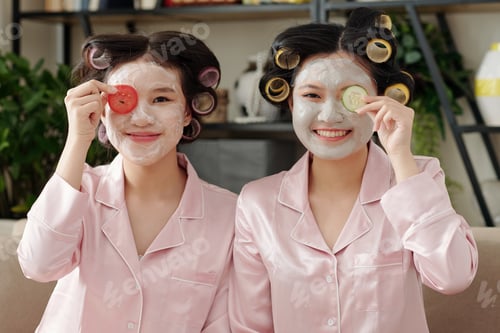 Preview: Joyful women applying clay masks