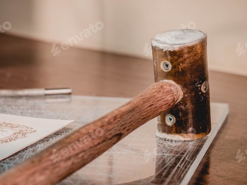 Preview: wooden hammer lies on the table in a leather processing workshop