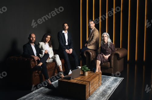 Preview: Hispanic Successful Business Team Sitting In Luxury Dark Office