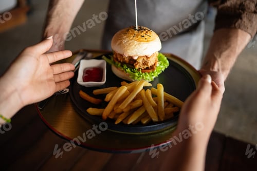 Preview: Waiter serves a fresh burger and fries in stylish restaurant, capturing the essence of great service