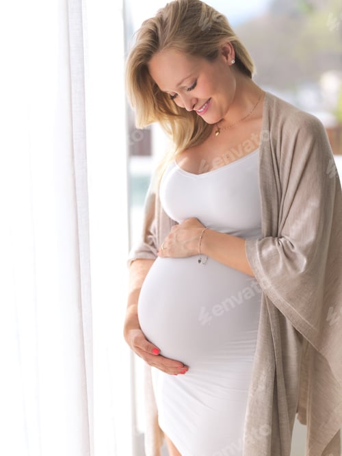 Preview: You can see the excitement. Cropped shot of a beautiful young pregnant woman standing in her home.