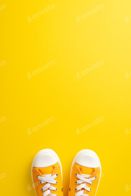 Preview: Going to school by feet concept. Above view vertical picture displaying a pair of bright