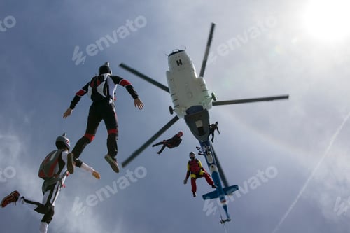Preview: Low angle view of helicopter and six skydivers free falling, Siofok, Somogy, Hungary