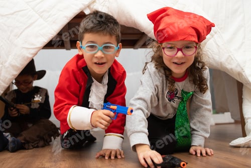 Preview: Small children dress up like pirates playing together indoors
